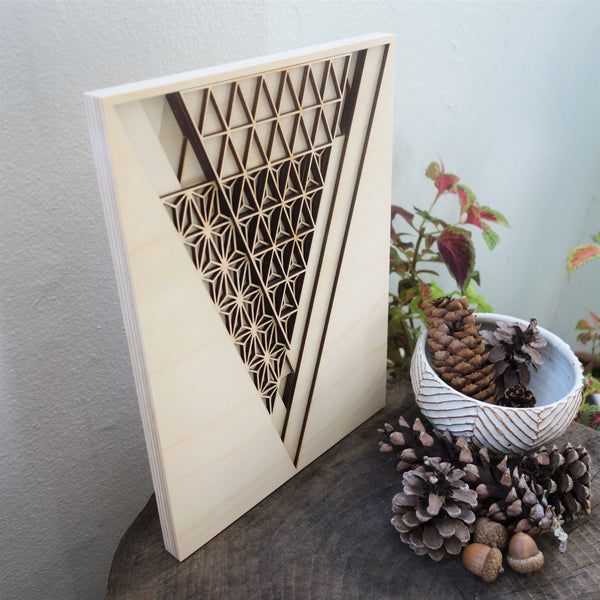 Wood artwork displayed on log